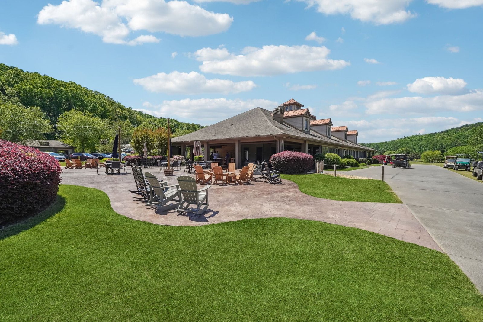 Achasta Golf Community clubhouse with outdoor patio seating and North Georgia mountains in the background